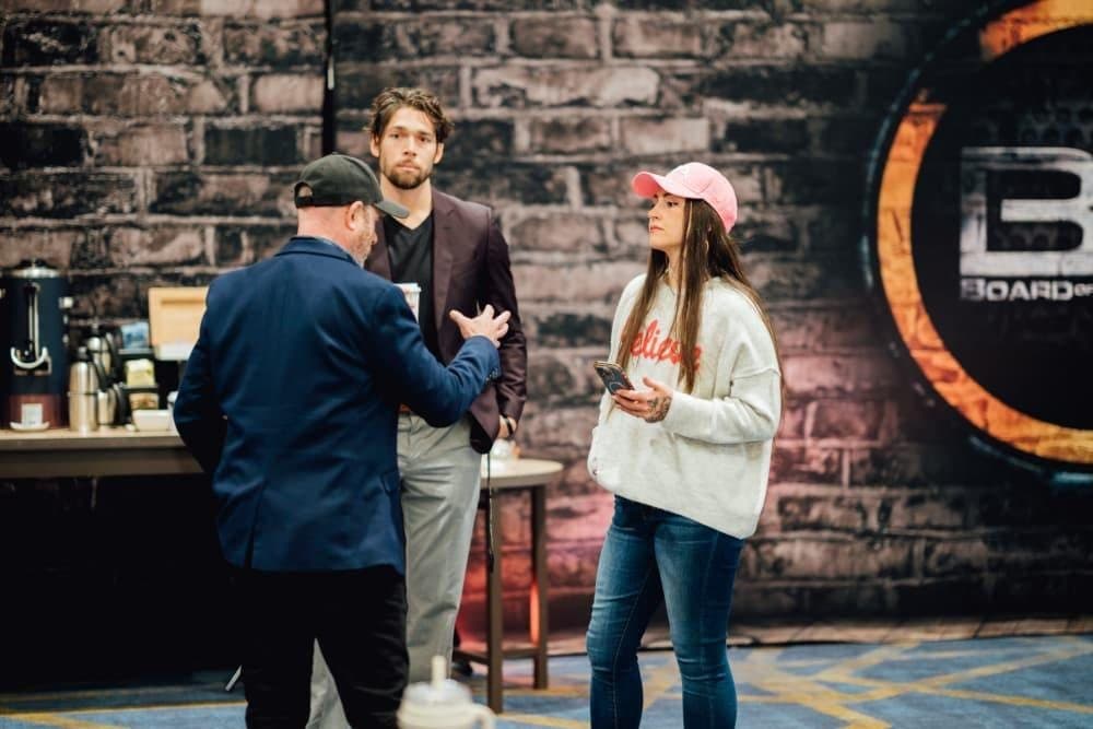 Breanna talking with other builders in the event room